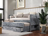 A rustic weathered black wood-framed captains bed with a pull-out trundle and 3 drawers styled in a modern bedroom setting